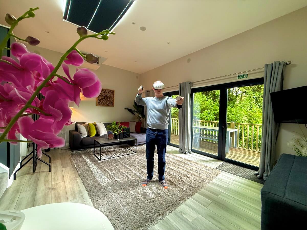 Room-scale VR setup with orchid views and soft furnishings.