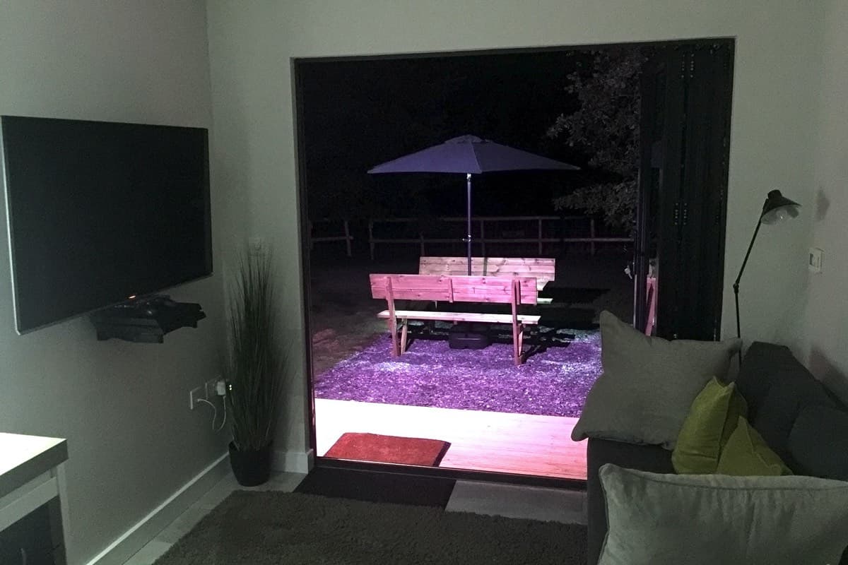Gazing at the mesmerizing night sky from the open bifold doors of the Ecopod
