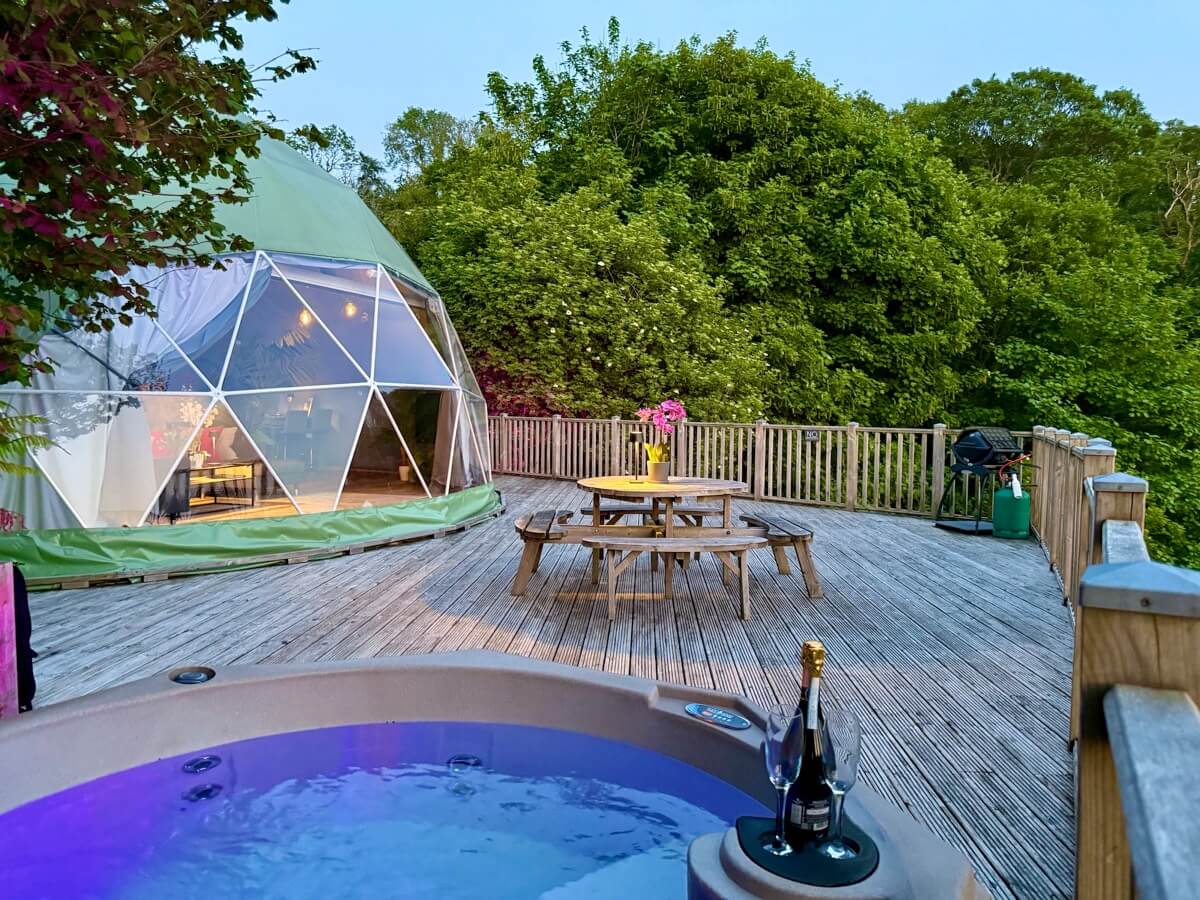 Sunridge Geodome at dusk with hot tub and prosecco.