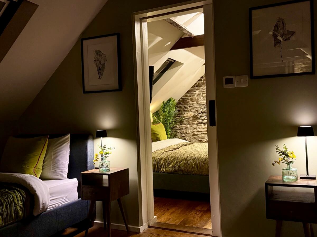 Twin bedroom at night with sidelamps.