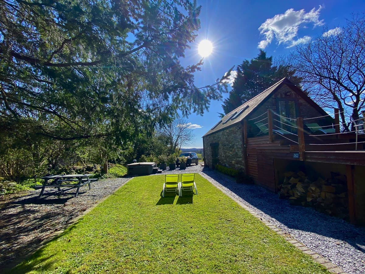 Relaxing in the sun-drenched garden with comfortable sun loungers at Sunridge Lodge