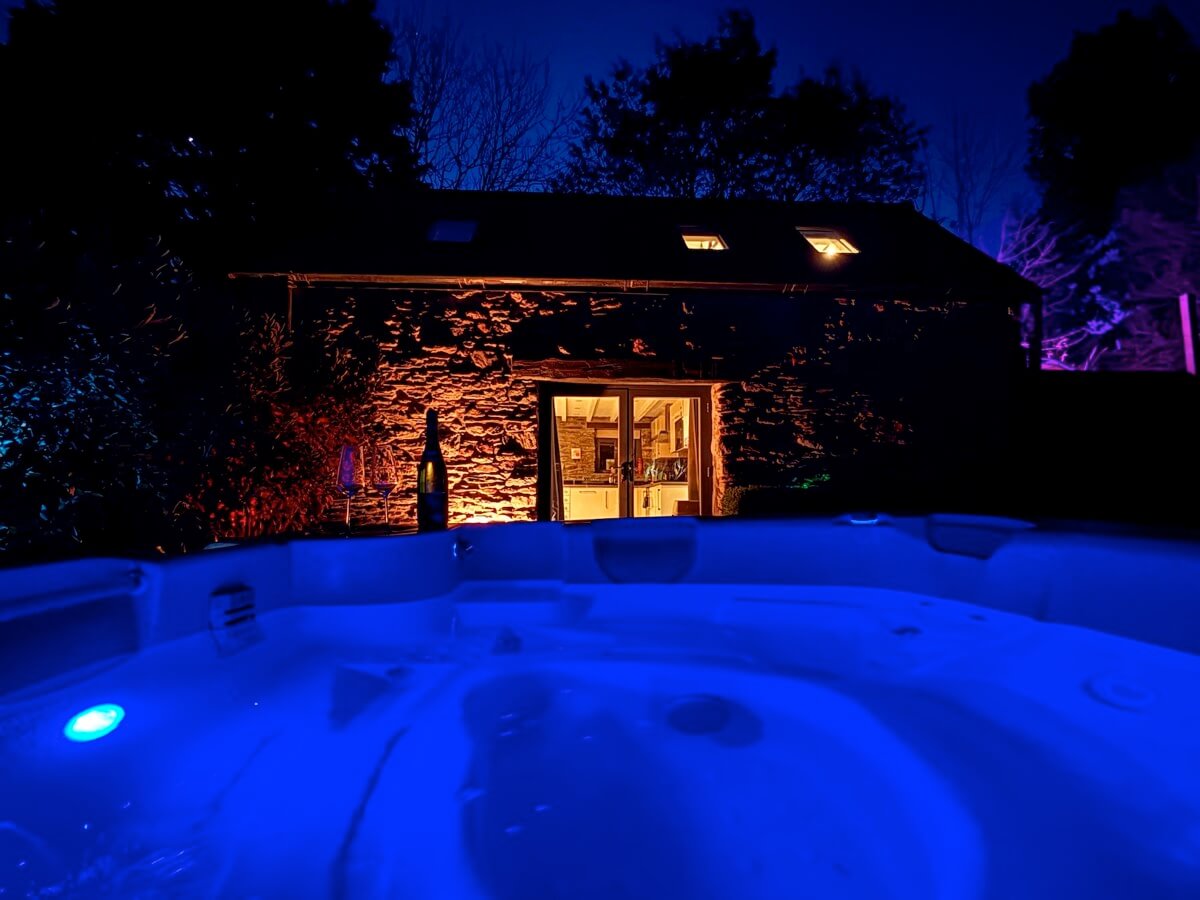 Glowing hot tub under the stars at night.