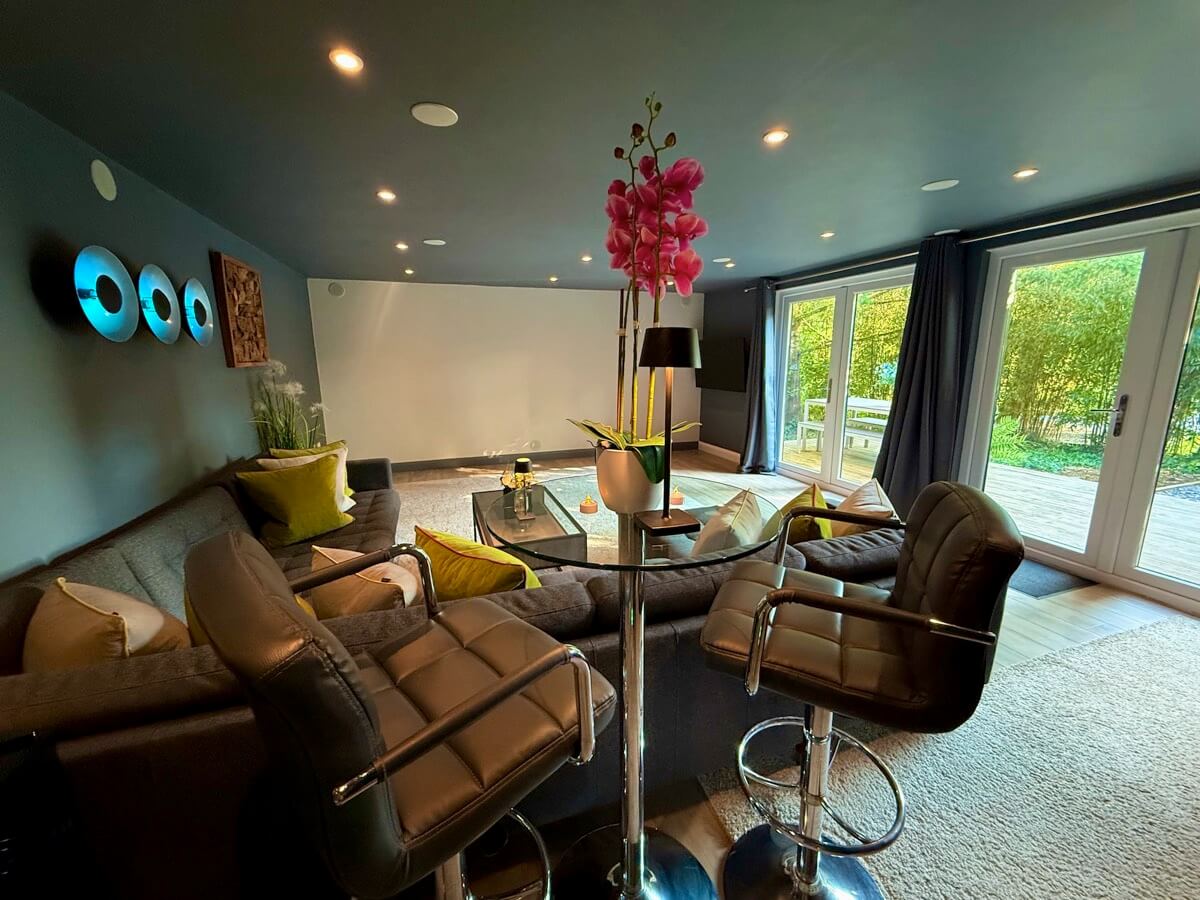 Cinema seating with bar table and orchid centrepiece.
