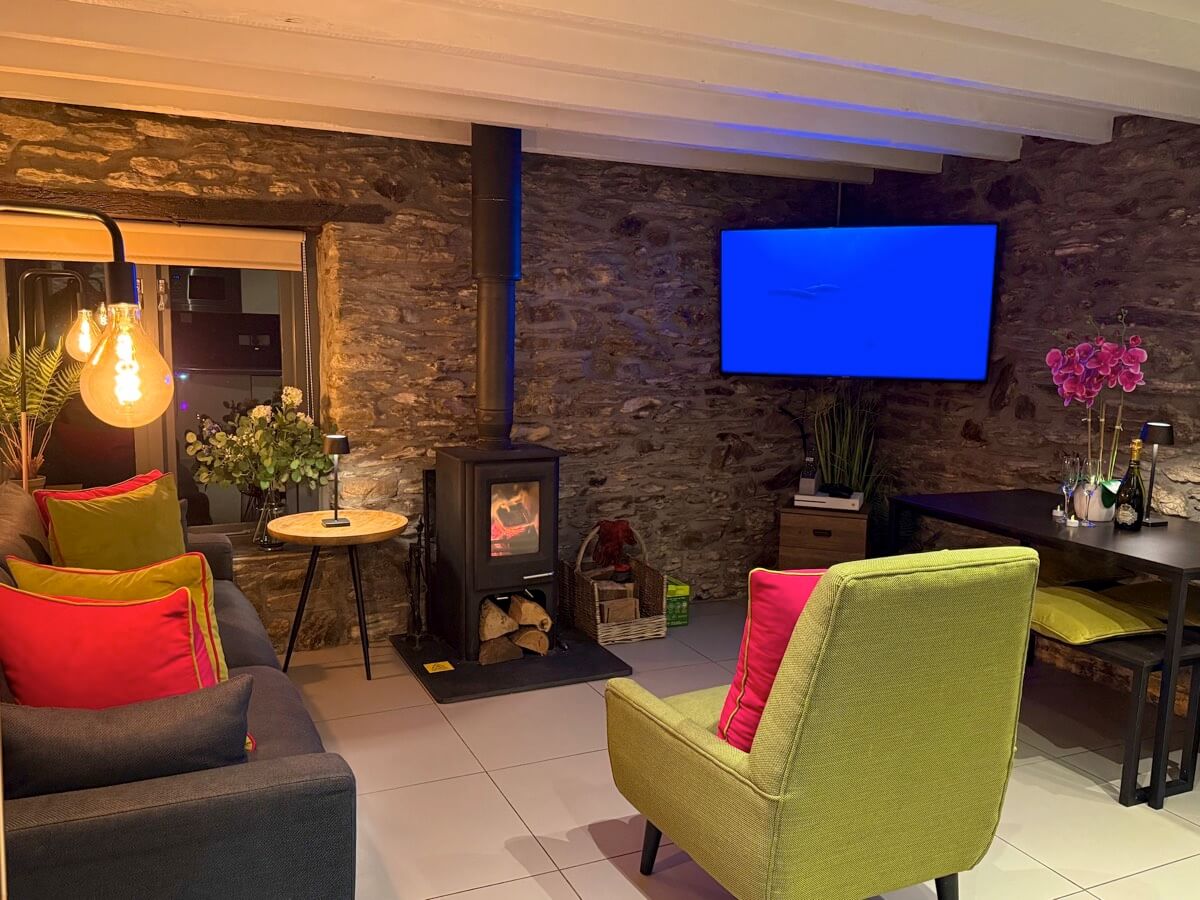 Sunridge Lodge log burner in mood lit lounge.