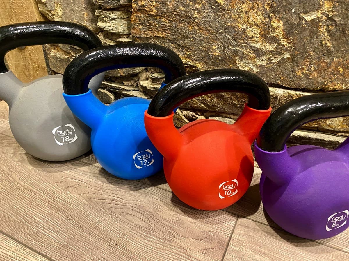 Adjustable weighted Bowflex dumbbells and kettlebell collection for strength training at the treehouse.