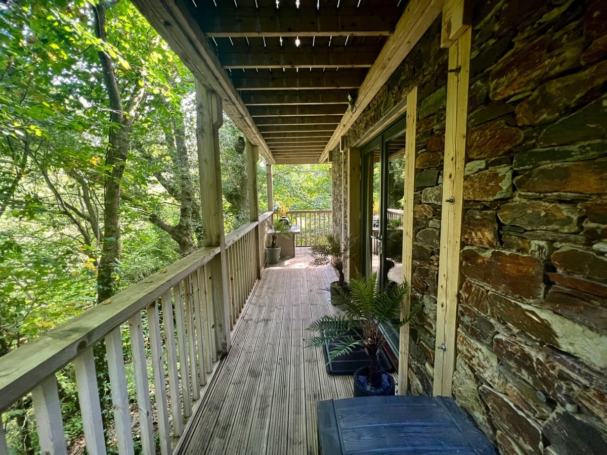Intimate lower deck of the treehouse, embraced by Devon